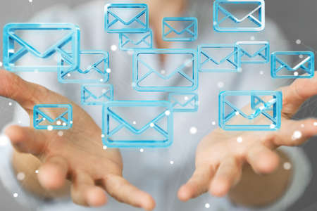 Businesswoman on blurred background holding and touching floating emails 3D renderingの写真素材