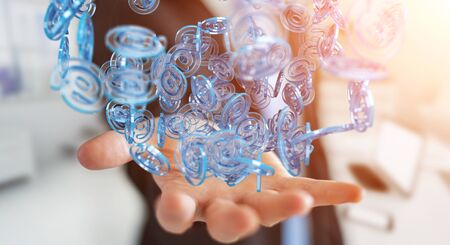Businessman on blurred background using digital arobase blue sphere to surf on internet 3D renderingの写真素材
