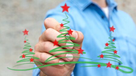 Businessman on blurred background drawing christmas trees sketchの写真素材