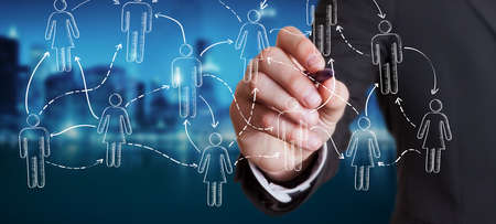 Businessman on blurred background drawing social network sketch with a penの写真素材