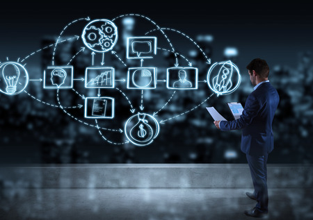 Businessman watching a project sketch on a rooftop with a city view 3D renderingの写真素材