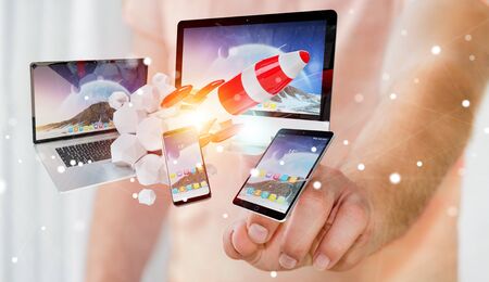 Businessman on blurred background connecting tech devices and startup rocket 3D renderingの写真素材
