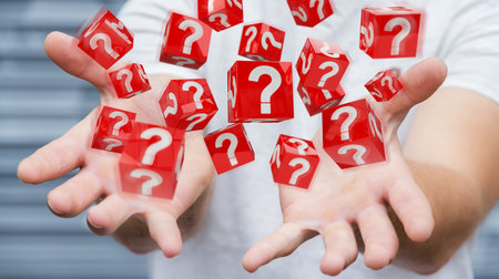 Businessman on blurred background using cubes with 3D rendering question marks