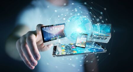 Businessman connecting tech devices and icons applications with each other 3D renderingの写真素材