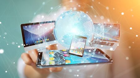 Businesswoman connecting tech devices and icons applications with each other 3D renderingの写真素材