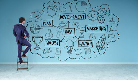 Businessman in modern interior watching a project sketch on a wall 3D renderingの写真素材