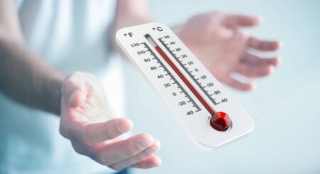 Businessman checking the temperature rise with a thermometer 3D renderingの写真素材