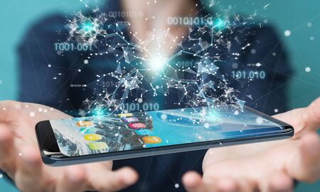 Businesswoman on blurred background using digital binary code on mobile phone 3D renderingの写真素材