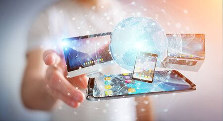 Businessman connecting tech devices and icons applications with each other 3D renderingの写真素材