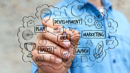 Businessman on blurred background drawing manuscript project presentation with a penの写真素材