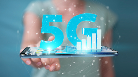 Businesswoman on blurred background using 5G network with mobile phone 3D renderingの写真素材