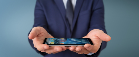 Businessman using modern mobile phone on blurred backgroundの写真素材
