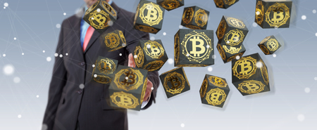 Businessman on blurred background using bitcoins cryptocurrency 3D renderingの写真素材