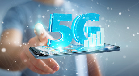 Businessman on blurred background using 5G network with mobile phone 3D renderingの写真素材