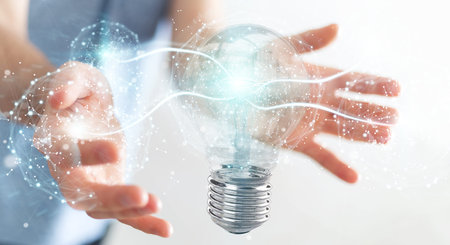 Businessman on blurred background connecting modern lightbulbs with connections 3D rendering
