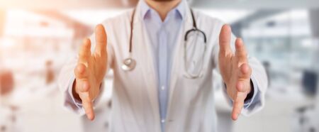 Doctor on blurred background giving empty handsの写真素材
