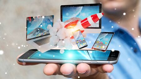 Businessman on blurred background connecting tech devices and startup rocket 3D renderingの写真素材