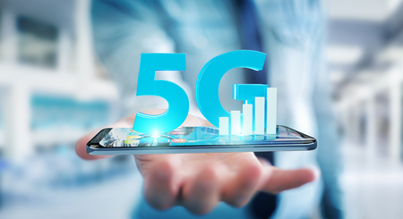 Businessman on blurred background using 5G network with mobile phone 3D renderingの写真素材
