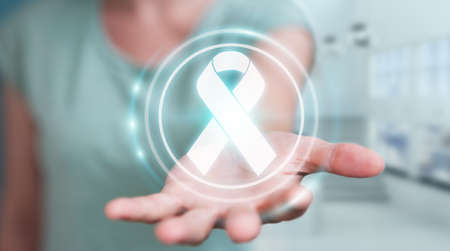 Businesswoman on blurred background using digital ribbon cancer interface 3D renderingの写真素材