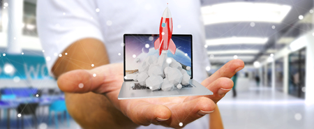 Businessman on blurred background with rocket launching from a laptop 3D renderingの写真素材
