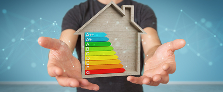 Businessman on blurred background using 3D rendering energy rating chart in a wooden houseの写真素材