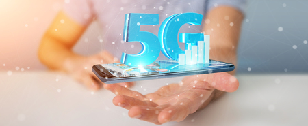 Businessman on blurred background using 5G network with mobile phone 3D renderingの写真素材