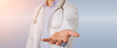 Doctor on blurred background giving empty handsの写真素材