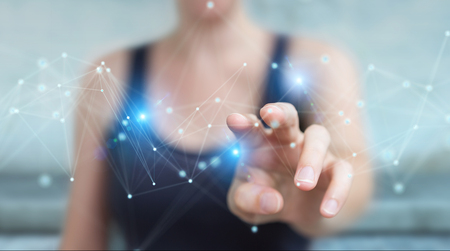 Businesswoman on blurred background using futuristic connection interface 3D renderingの写真素材