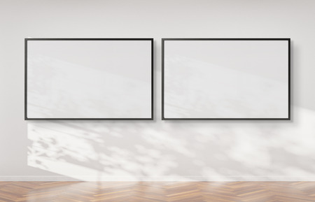 Two horizontal frames hanging on a white wall mockup 3d renderingの写真素材