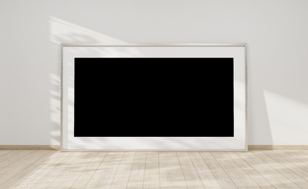 Large horizontal frame leaning on a white wall in wooden interior 3D renderingの写真素材