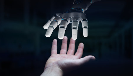 Robot hand making contact with human hand on dark background 3D renderingの写真素材