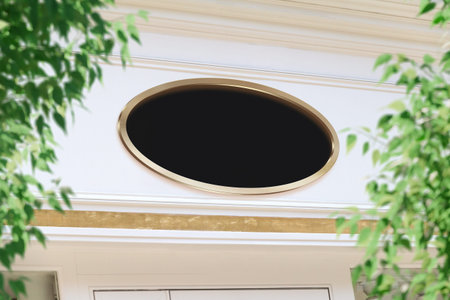 Oval storefront golden frame Mockup. Empty store brand signboard on a shop frontage