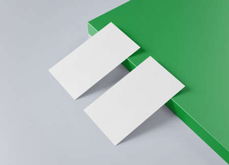 Two white US business card Mockup laying on green and gray background. American size calling card front and back laying on colored surface 3D renderingの写真素材