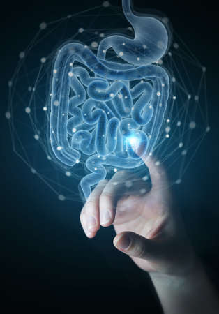 Man hand on dark background using digital x-ray of human intestine holographic scan projection 3D renderingの写真素材
