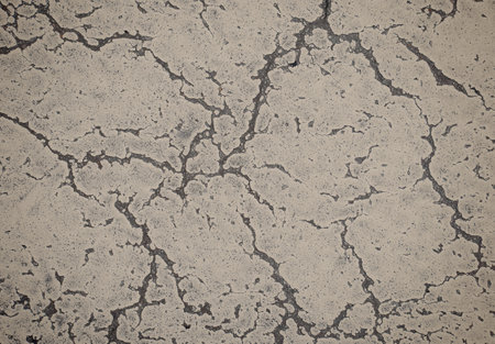 Grunge cracked texture of an old dirty floor. Background of damaged stoneの写真素材