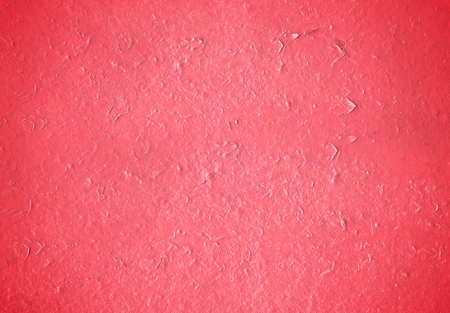 Red grunge texture of a painted wall. Background of damaged paint surfaceの写真素材