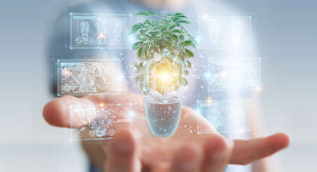Man on blurred background holding and touching holographic projection of a plant with digital analysis 3D renderingの写真素材