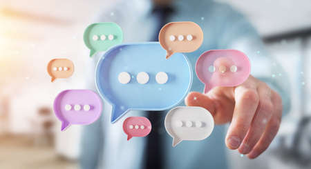 Man touching with his fingers digital colorful speech bubbles talk icons. Minimal conversation or social media messages floating in front of businessman hand. 3D renderingの写真素材