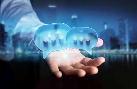 Businessman in dark using digital blue speech bubbles talk icons. Minimal conversation or social media messages floating over user hand. 3D renderingの写真素材