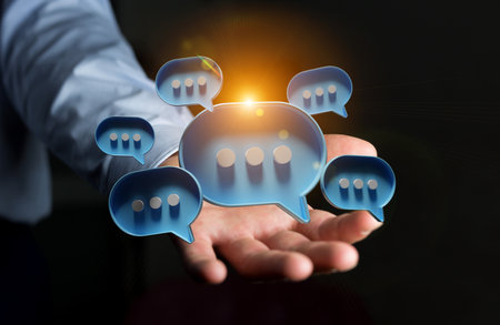Businessman in dark using digital blue speech bubbles talk icons. Minimal conversation or social media messages floating over user hand. 3D renderingの写真素材