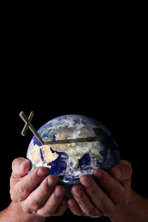 Religious concept.  God's hands holding world with cross on isolated black background. Earth image courtesy of NASA.の写真素材