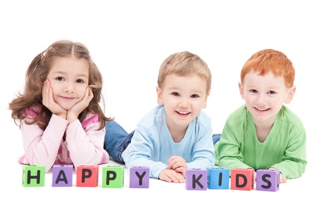Three happy children with kids blocks. Isolated on white.の写真素材