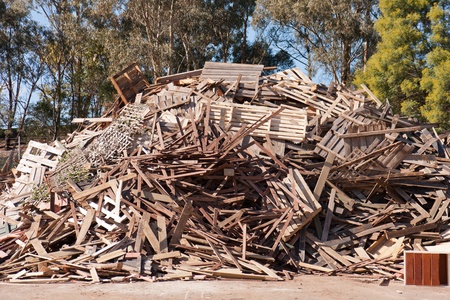 Pile of raw timber for recycling at waste depotの写真素材