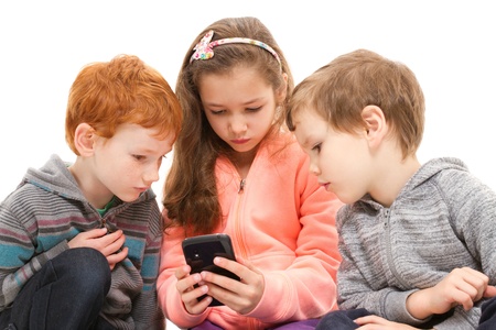 Group of kids using black smartphone. Isolated on white.の写真素材