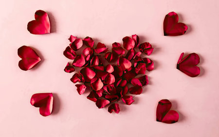 Red heart made of rose petals on pink background. Valentines day concept.の素材