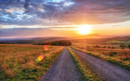 Sunset over a dirt road in the Peak District National Park, UKの素材