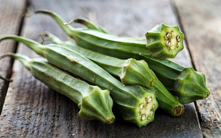 fresh okra on a wooden table, food closeup, verticalの素材