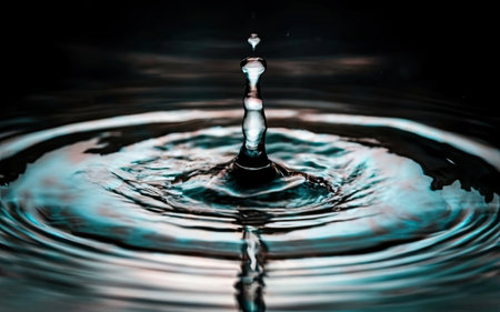 Water drop collision on a wet background. Water Drop collision with water Surfaceの素材
