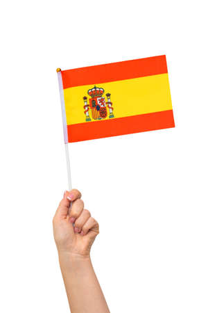 Female hand holding Spanish flag, isolated on white backgroundの写真素材