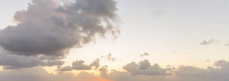 Panoramic beautiful clouds against the background of the sunの写真素材